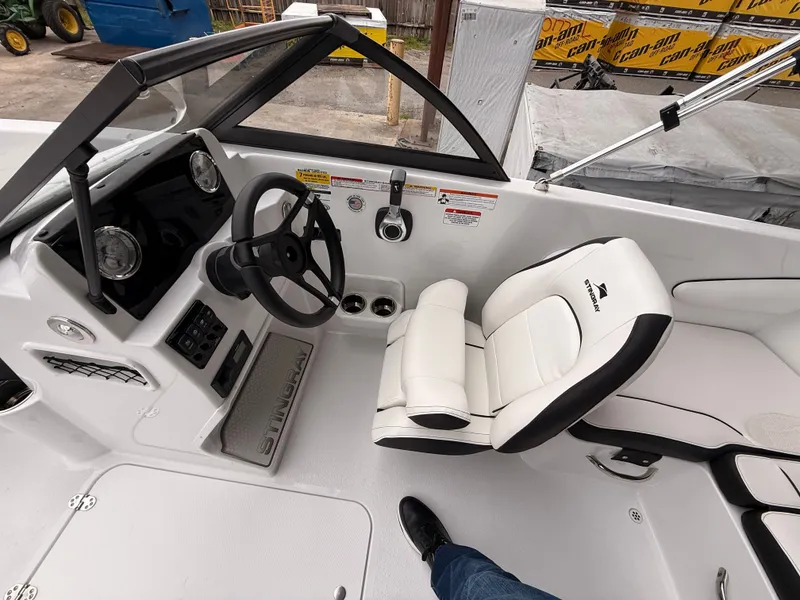 Slide: The Image of Interior of a 2025 Stingray 172 DC boat with white seating. - 22