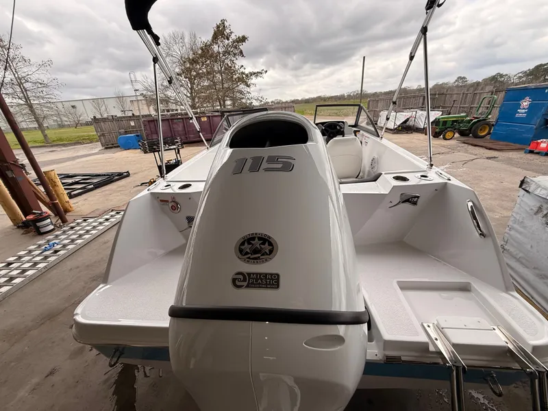 Slide: The Image of Stingray 172 DC 2025 boat with outboard motor, parked outdoors. - 41