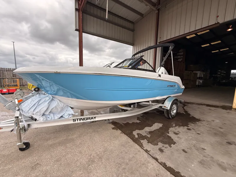Slide: The Image of 2025 Stingray 172 DC boat on trailer in warehouse. - 44