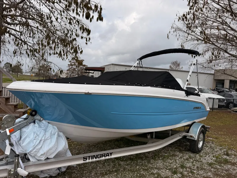 Slide: The Image of 2025 Stingray 172 DC boat on trailer, blue and white. - 49