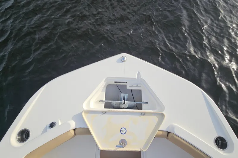 Slide: The Image of Bow view of 2021 NauticStar 191 Hybrid boat on water. - 12