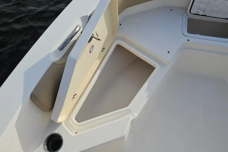 Slide: The Image of 2021 NauticStar 191 Hybrid boat storage compartment with open hatch, showcasing interior space. - 13
