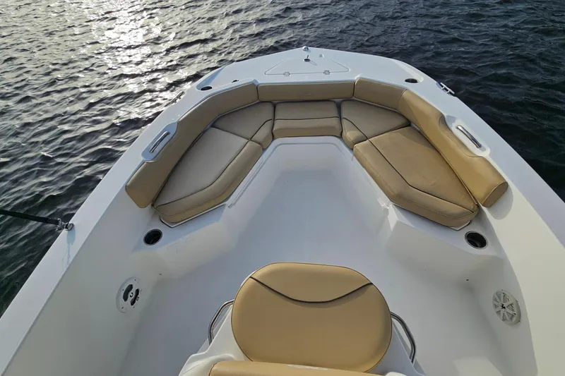 Slide: The Image of 2021 NauticStar 191 Hybrid boat interior with tan seating, on water. - 15