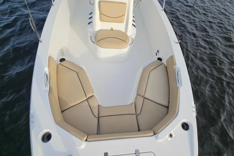 Slide: The Image of 2021 NauticStar 191 Hybrid boat interior with tan seating on water. - 16