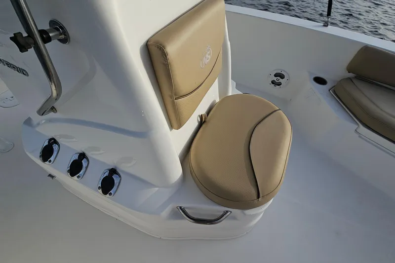 Slide: The Image of 2021 NauticStar 191 Hybrid boat interior with tan seating and control panel. - 18