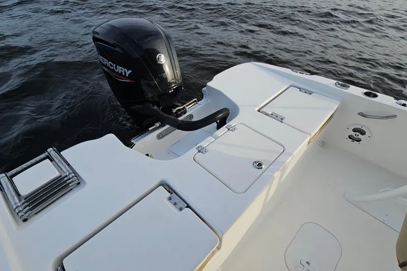 Slide: The Image of 2021 NauticStar 191 Hybrid boat with Mercury outboard engine on water. - 21
