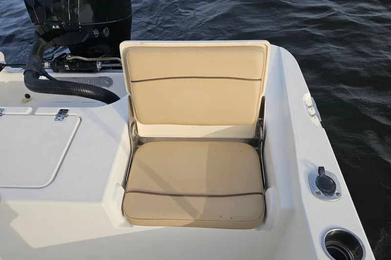 Slide: The Image of 2021 NauticStar 191 Hybrid boat seat with beige upholstery, near water. - 22