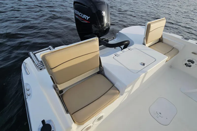Slide: The Image of 2021 NauticStar 191 Hybrid boat with Mercury engine, featuring comfortable seating and storage. - 24