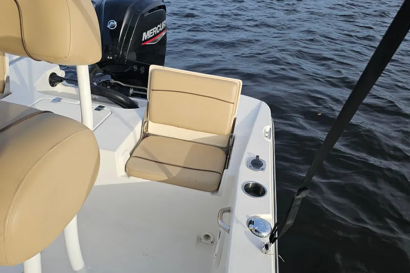 Slide: The Image of 2021 NauticStar 191 Hybrid boat interior with tan seating and Mercury engine. - 26