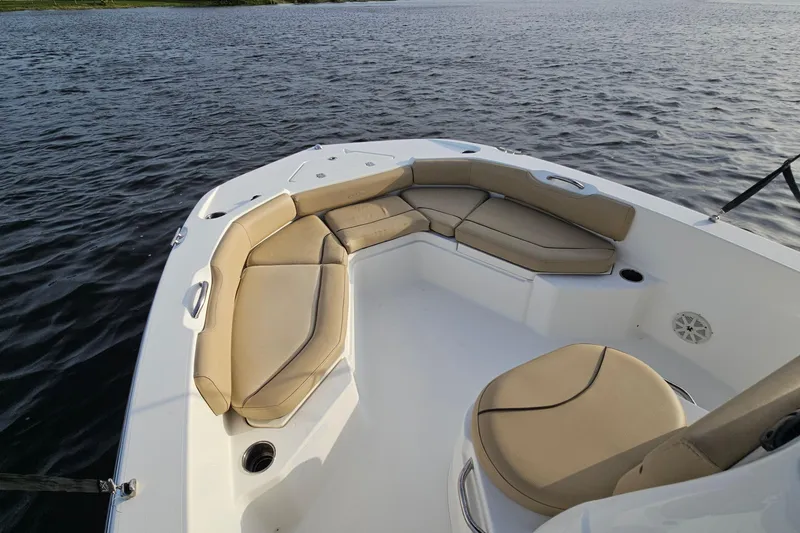 Slide: The Image of 2021 NauticStar 191 Hybrid boat with tan seating on calm water. - 27