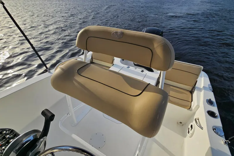 Slide: The Image of 2021 NauticStar 191 Hybrid boat with tan seating, on calm water. - 28