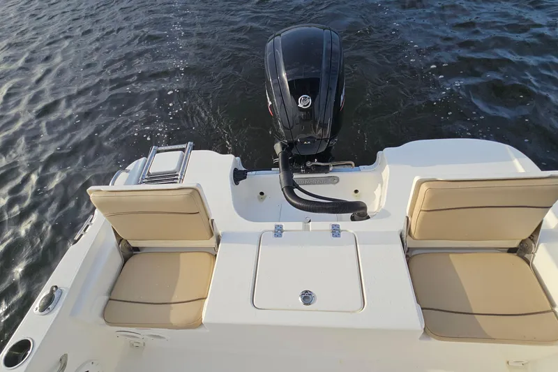 Slide: The Image of 2021 NauticStar 191 Hybrid boat with outboard motor and seating on water. - 29