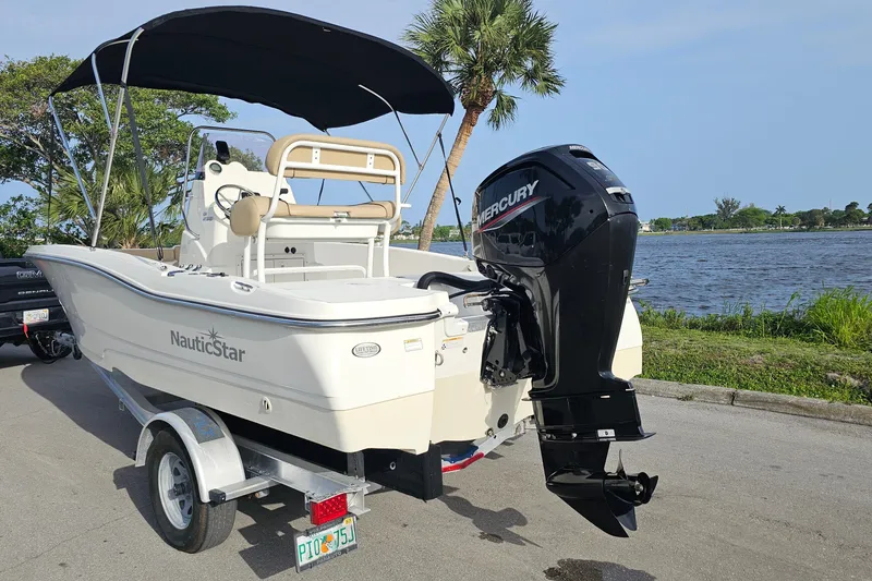 Slide: The Image of 2021 NauticStar 191 Hybrid boat with Mercury engine, parked near a scenic waterfront. - 3