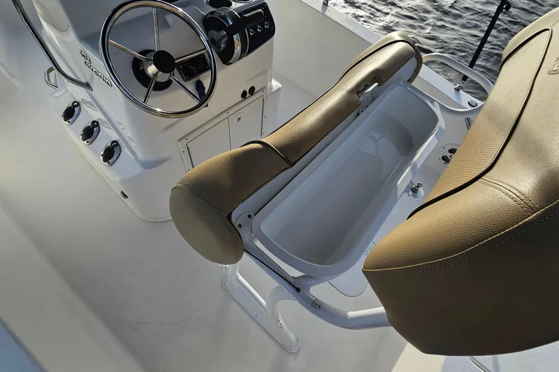 Slide: The Image of 2021 NauticStar 191 Hybrid boat interior with steering wheel and cushioned seating. - 30