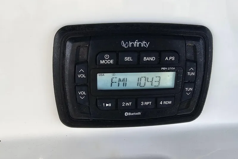 Slide: The Image of Infinity radio display on 2021 NauticStar 191 Hybrid, showing FM 104.3 frequency. - 34