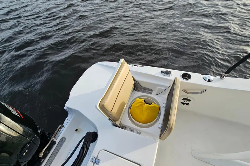 Slide: The Image of 2021 NauticStar 191 Hybrid boat with open storage compartment on water. - 39