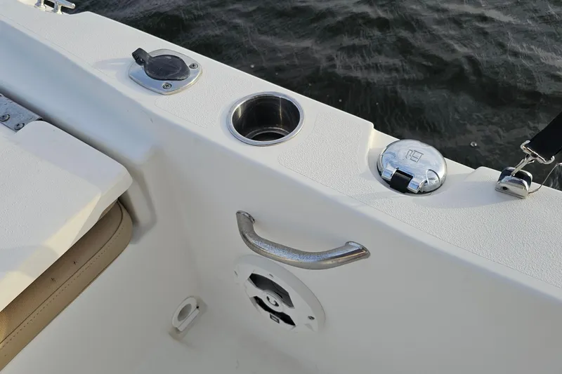 Slide: The Image of 2021 NauticStar 191 Hybrid boat interior with cup holder and handle, near water. - 40
