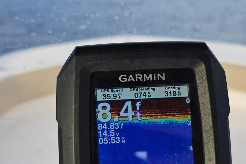 Slide: The Image of Garmin GPS display on 2021 NauticStar 191 Hybrid, showing speed, heading, and depth. - 42