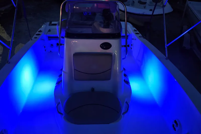 Slide: The Image of 2021 NauticStar 191 Hybrid boat interior with vibrant blue LED lighting. - 45