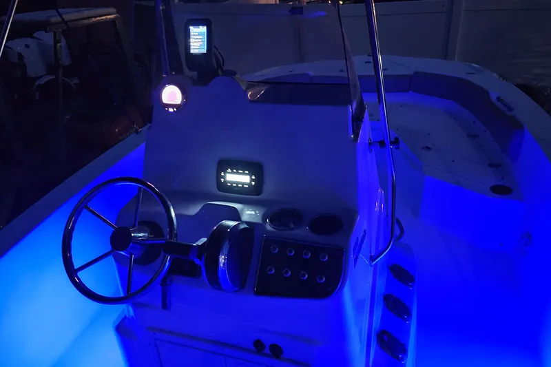 Slide: The Image of 2021 NauticStar 191 Hybrid boat interior with blue LED lighting at night. - 47