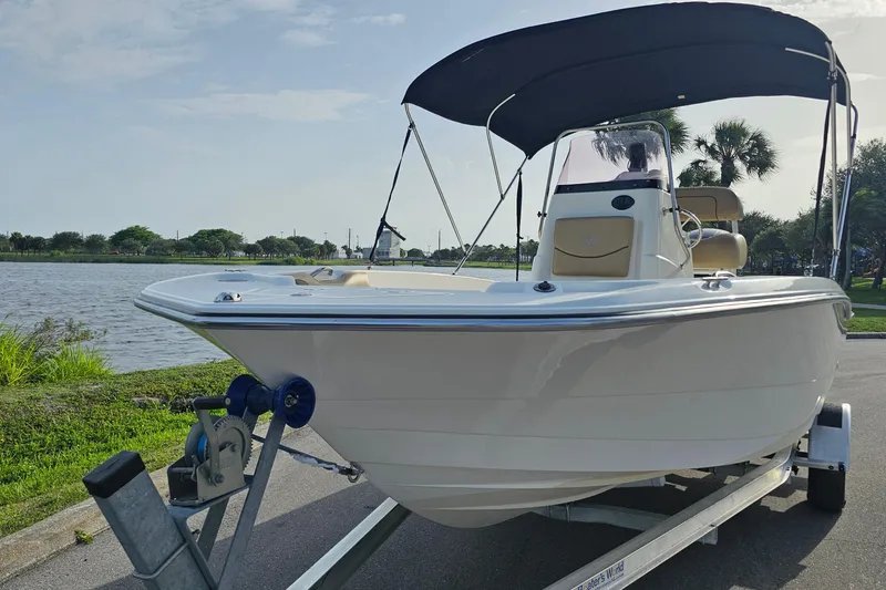 Slide: The Image of 2021 NauticStar 191 Hybrid boat on trailer by a scenic lake. - 7