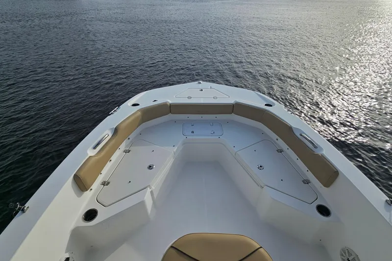 Slide: The Image of 2021 NauticStar 191 Hybrid boat bow with seating, on calm water. - 8