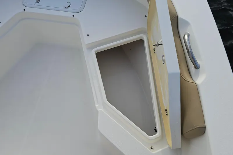 Slide: The Image of 2021 NauticStar 191 Hybrid boat storage compartment with open hatch and handle. - 9