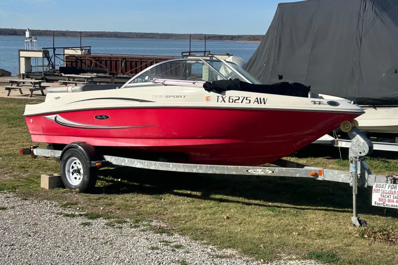 The Image of 2008 Sea Ray 175 Bow Rider boat on trailer by lakeside. - 1
