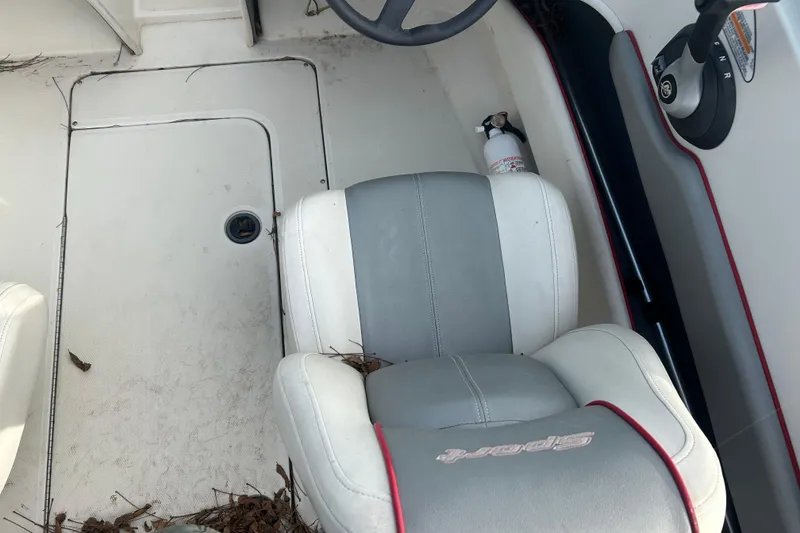 Slide: The Image of Interior of a 2008 Sea Ray 175 Bow Rider boat with steering wheel and seat. - 10