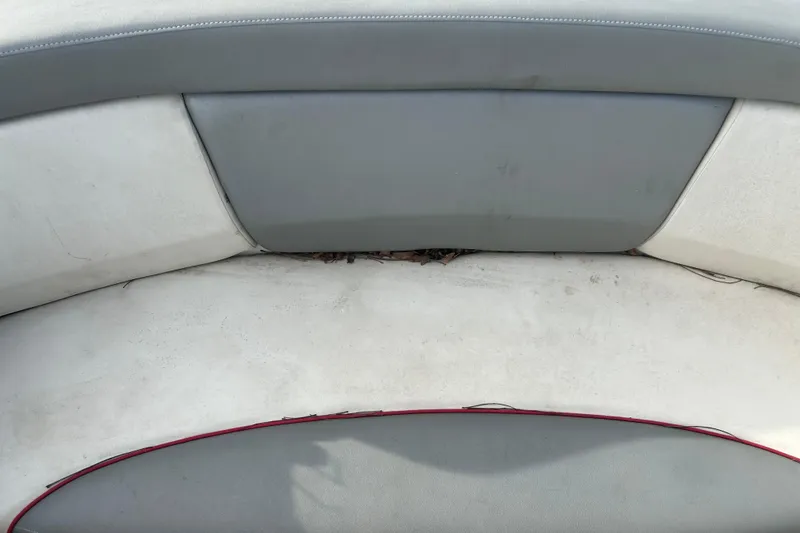 Slide: The Image of 2008 Sea Ray 175 Bow Rider interior seating with gray and white upholstery. - 11