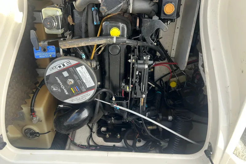 Slide: The Image of Engine compartment of a 2008 Sea Ray 175 Bow Rider boat, featuring a MerCruiser 3.0L engine. - 14