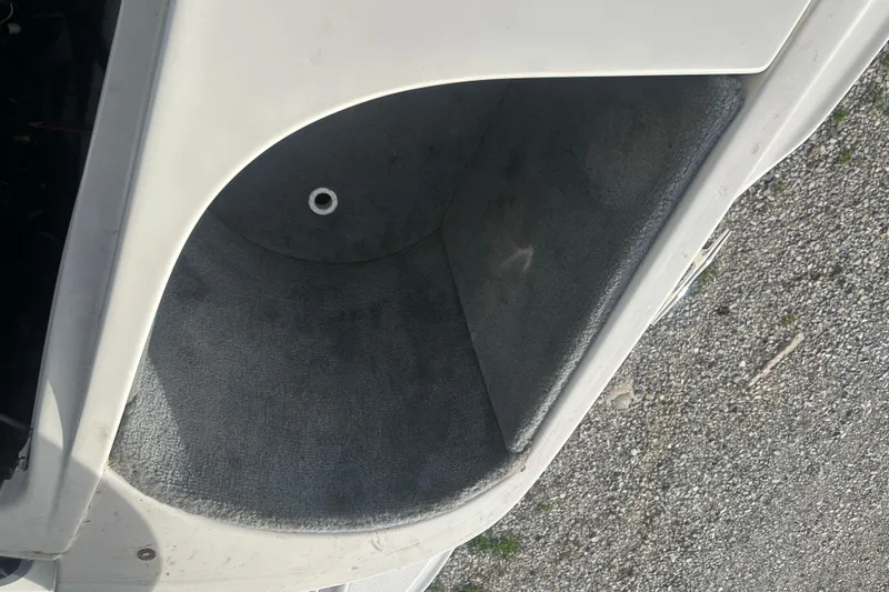 Slide: The Image of Storage compartment of a 2008 Sea Ray 175 Bow Rider boat, featuring gray carpeting. - 16