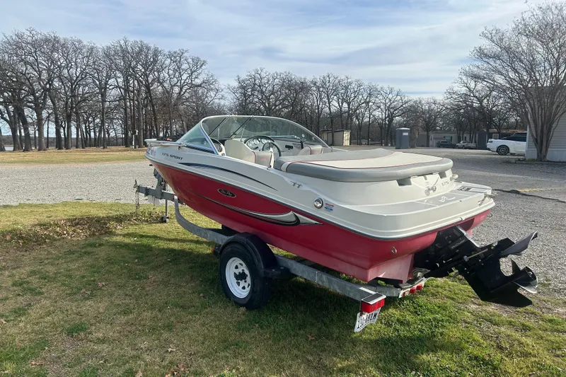Slide: The Image of 2008 Sea Ray 175 Bow Rider boat on trailer, parked outdoors on grass. - 3