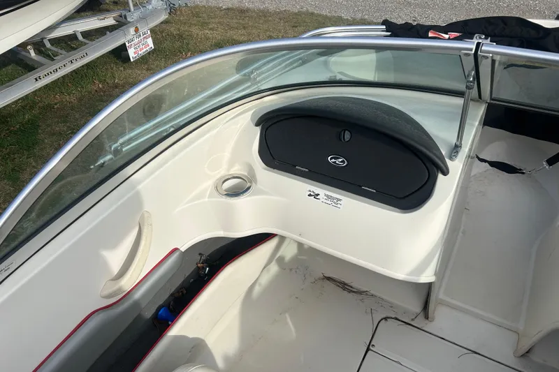 Slide: The Image of 2008 Sea Ray 175 Bow Rider interior with windshield and dashboard, for sale sign visible. - 8