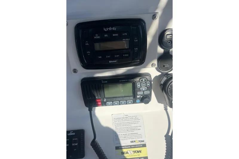 Slide: The Image of 2005 Edgewater 245CC boat dashboard with Infinity stereo and Icom marine radio. - 12