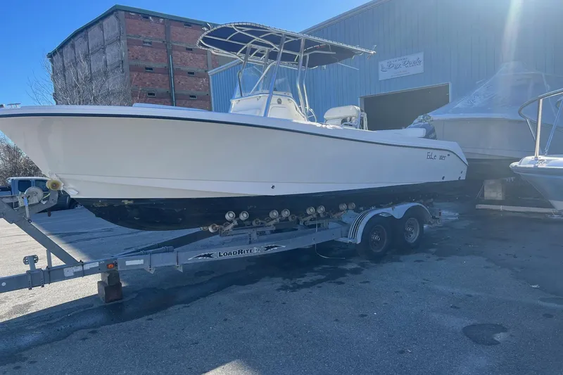 Slide: The Image of 2005 Edgewater 245CC boat on trailer, parked outside a warehouse. - 3
