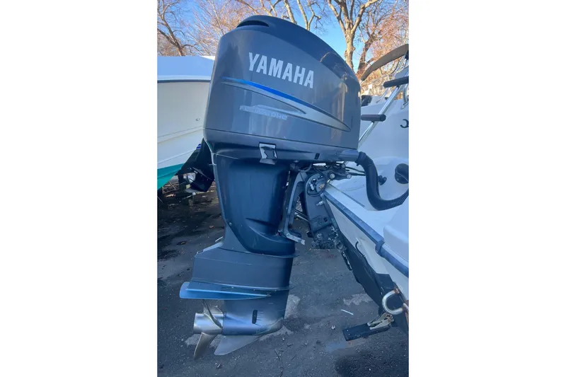 Slide: The Image of Yamaha outboard motor on a 2005 Edgewater 245CC boat, parked outdoors. - 9