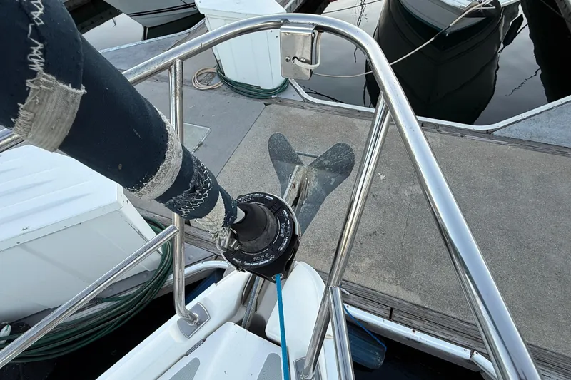 Slide: The Image of Bow view of a 2007 Hunter 31 sailboat docked, showing anchor and railing. - 10