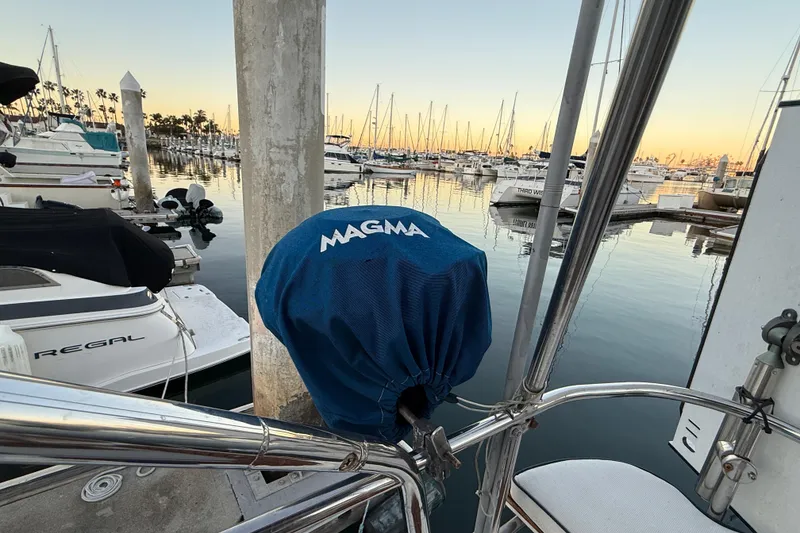 Slide: The Image of Marina view with boats, featuring a 2007 Hunter 31 sailboat and Magma grill cover. - 15