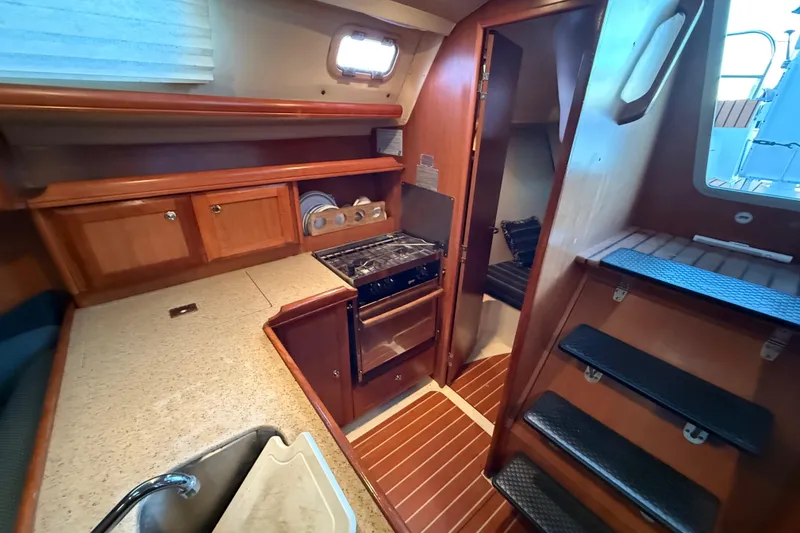 Slide: The Image of Interior of 2007 Hunter 31 sailboat with kitchen and wooden cabinetry. - 20