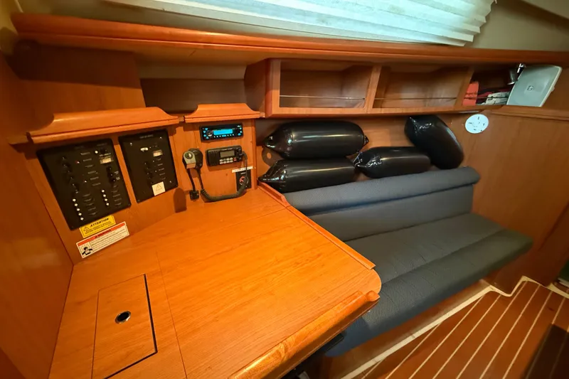 Slide: The Image of 2007 Hunter 31 yacht interior with navigation panel and seating area. - 23