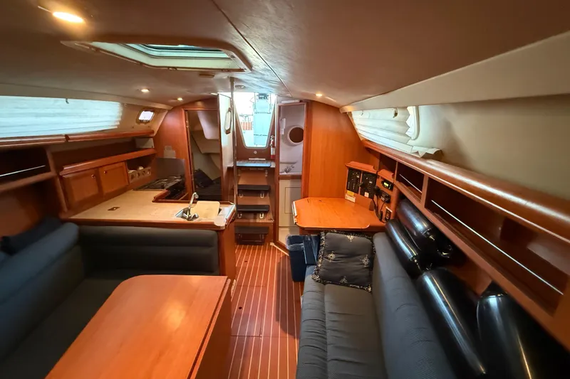 Slide: The Image of Interior of 2007 Hunter 31 sailboat with wood finish and cozy seating area. - 26