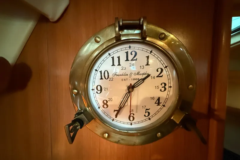 Slide: The Image of Brass nautical clock on 2007 Hunter 31 sailboat interior wall. - 28