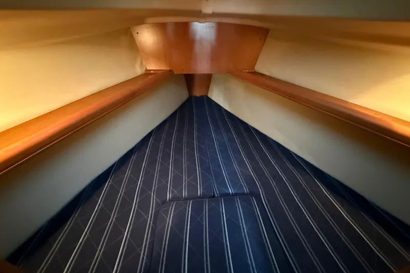 Slide: The Image of 2007 Hunter 31 sailboat interior with striped upholstery and wooden accents. - 29