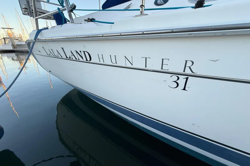 Slide: The Image of 2007 Hunter 31 sailboat named "La La Land" docked at marina. - 3