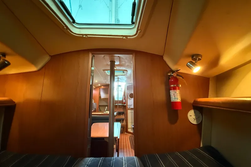 Slide: The Image of Interior of a 2007 Hunter 31 sailboat, featuring cozy cabin and wooden finishes. - 30