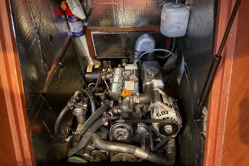 Slide: The Image of Engine compartment of a 2007 Hunter 31 sailboat, featuring detailed mechanical components. - 32