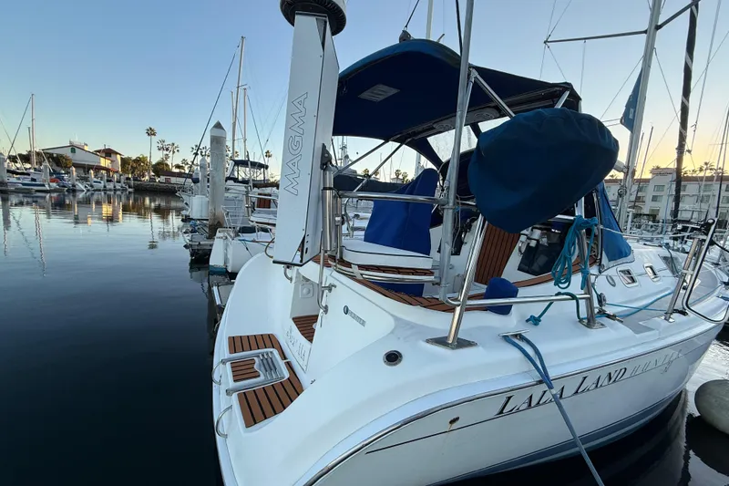 Slide: The Image of Hunter 31 sailboat from 2007 docked in a marina at sunset. - 4