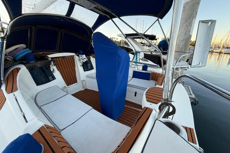 Slide: The Image of Cockpit of a 2007 Hunter 31 sailboat with cushioned seating and blue canopy. - 5