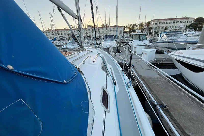 Slide: The Image of Sailboat docked in marina, Hunter 31 model, 2007, with blue cover. - 7
